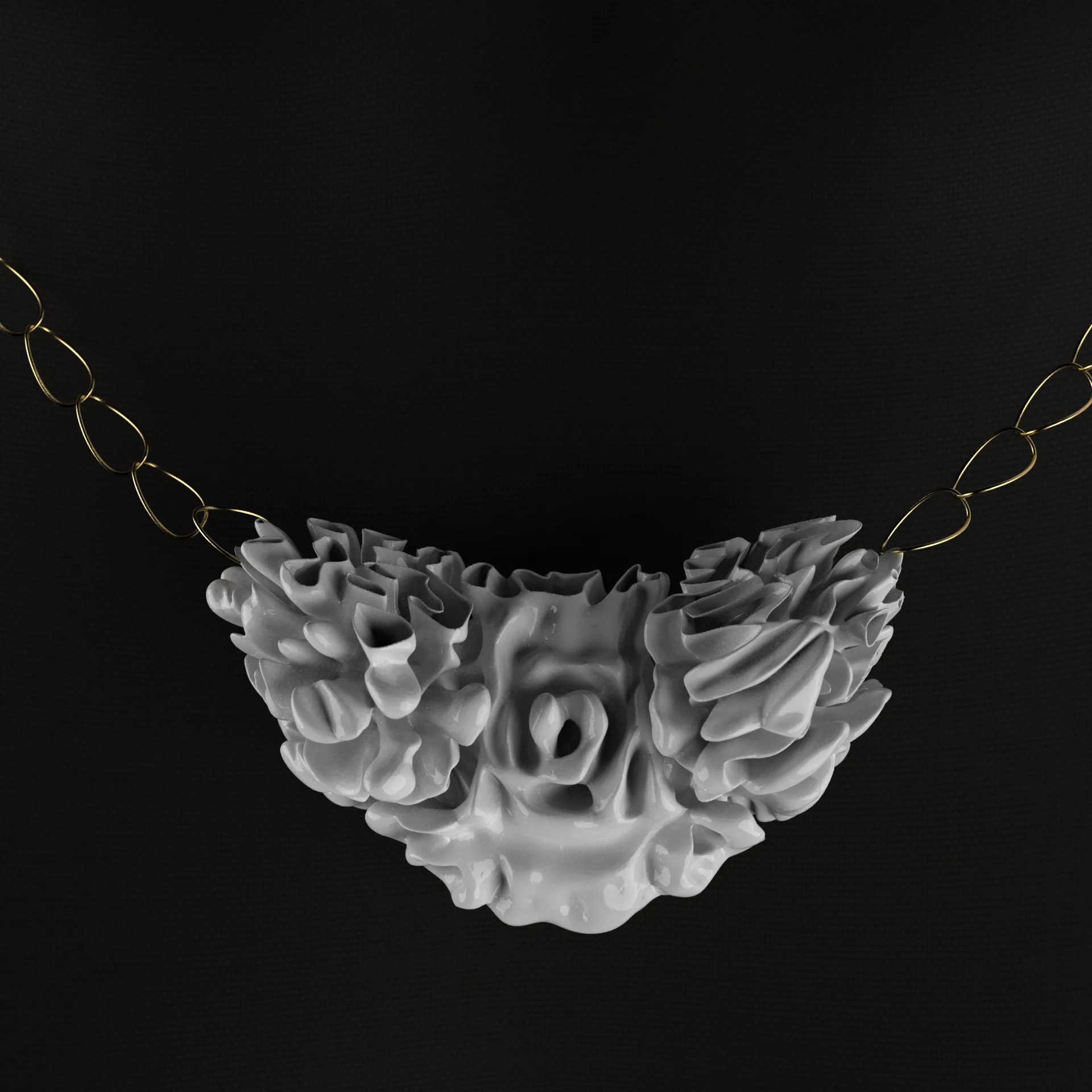 White coral-textured pendant on gold chain against black background